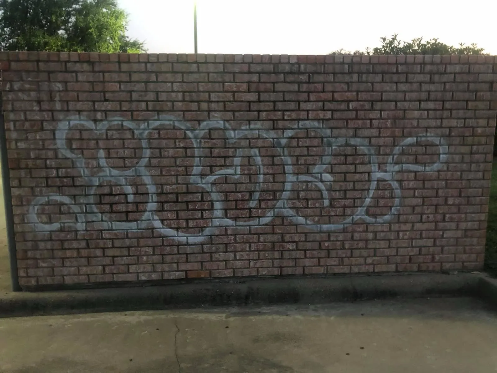 Brick building exterior with graffiti before cleaning