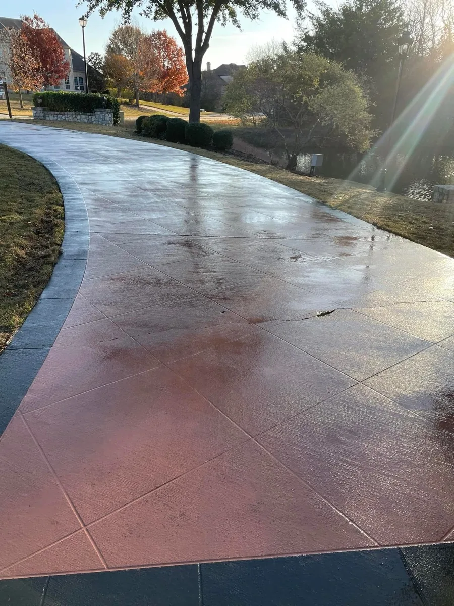 Stamped concrete driveway after pressure washing, wet and clean