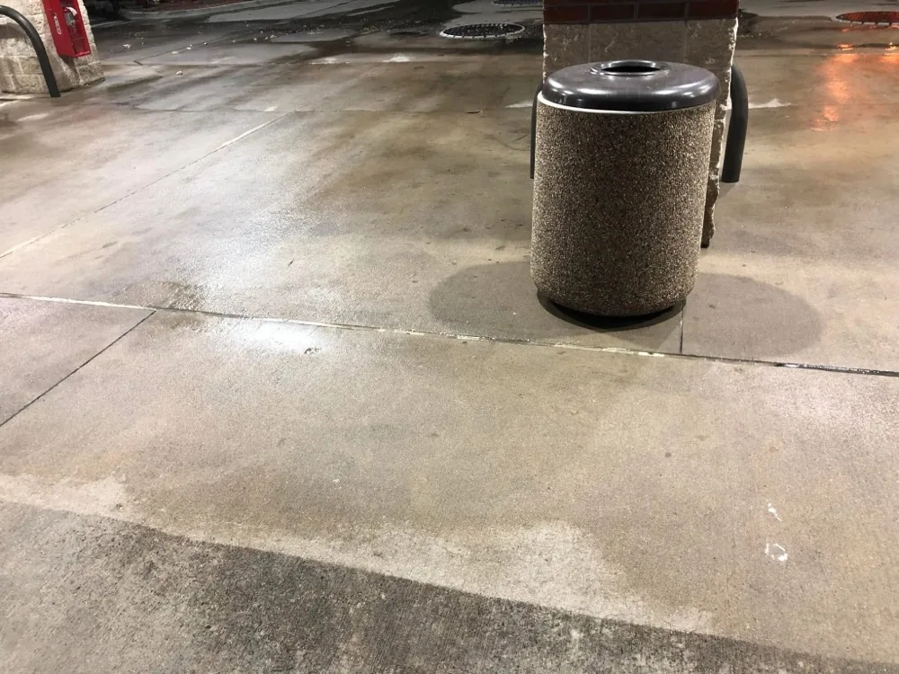 Convenience store trash area with clean concrete after pressure washing